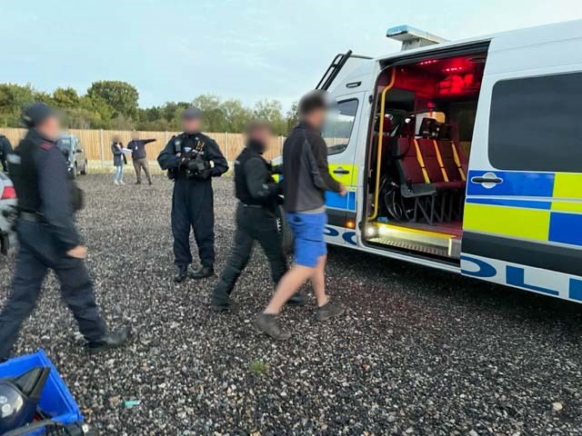 Essex Police Officers arresting a man and taking him to a police van